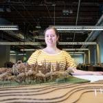 Landscape architecture student with model landscape